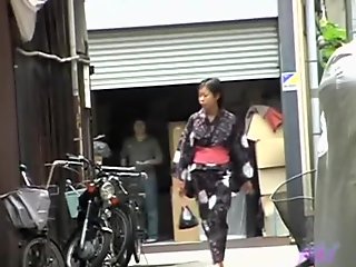 Cute Asian in a jukata has boob sharking on the street.